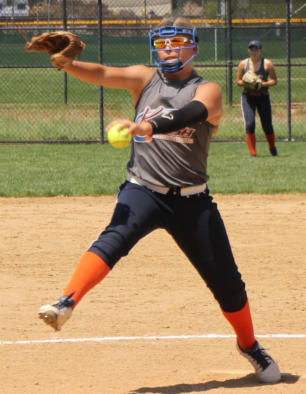Softball pitcher delivering a pitch during a game