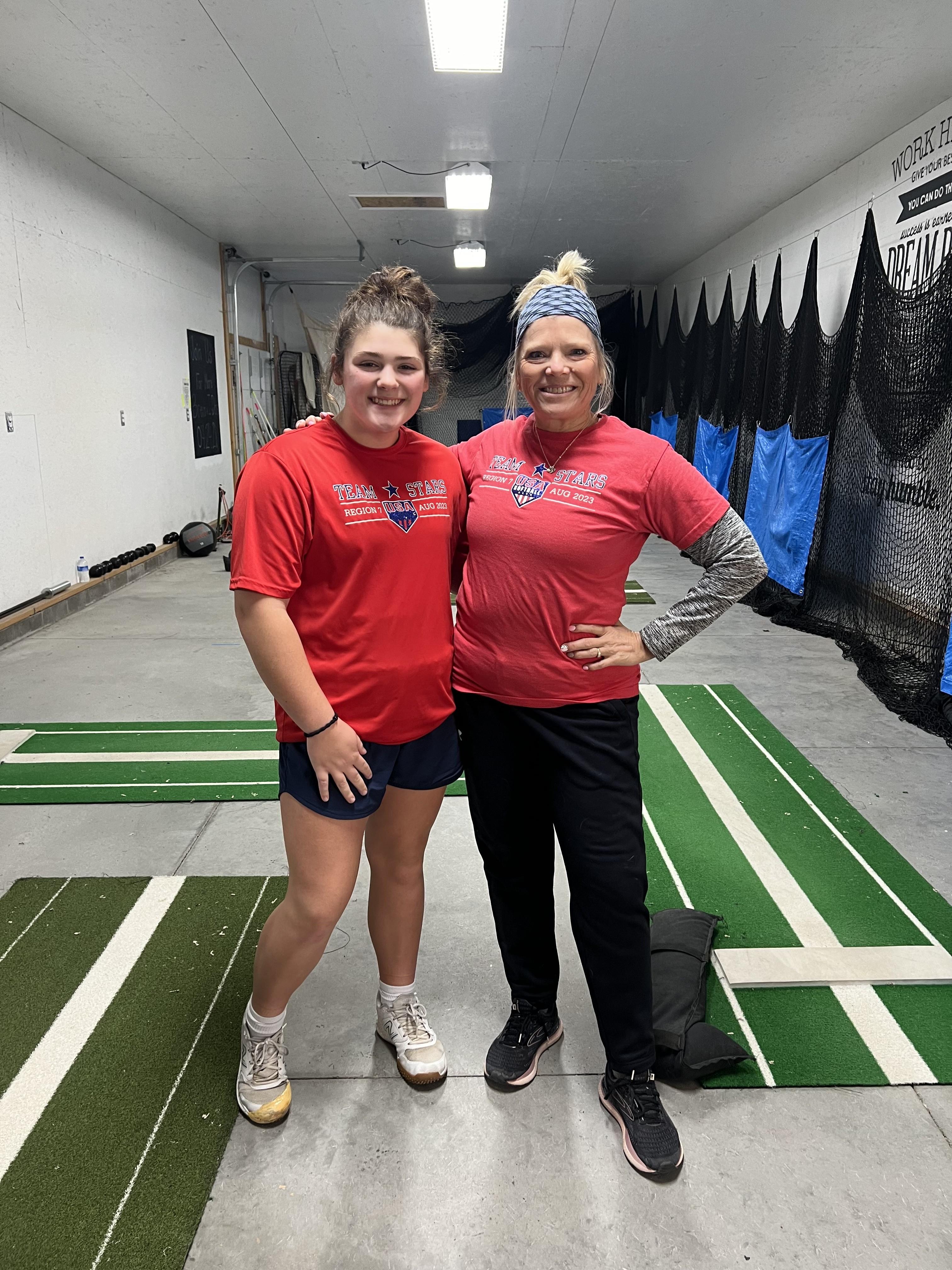Coach and player posing together in the training facility