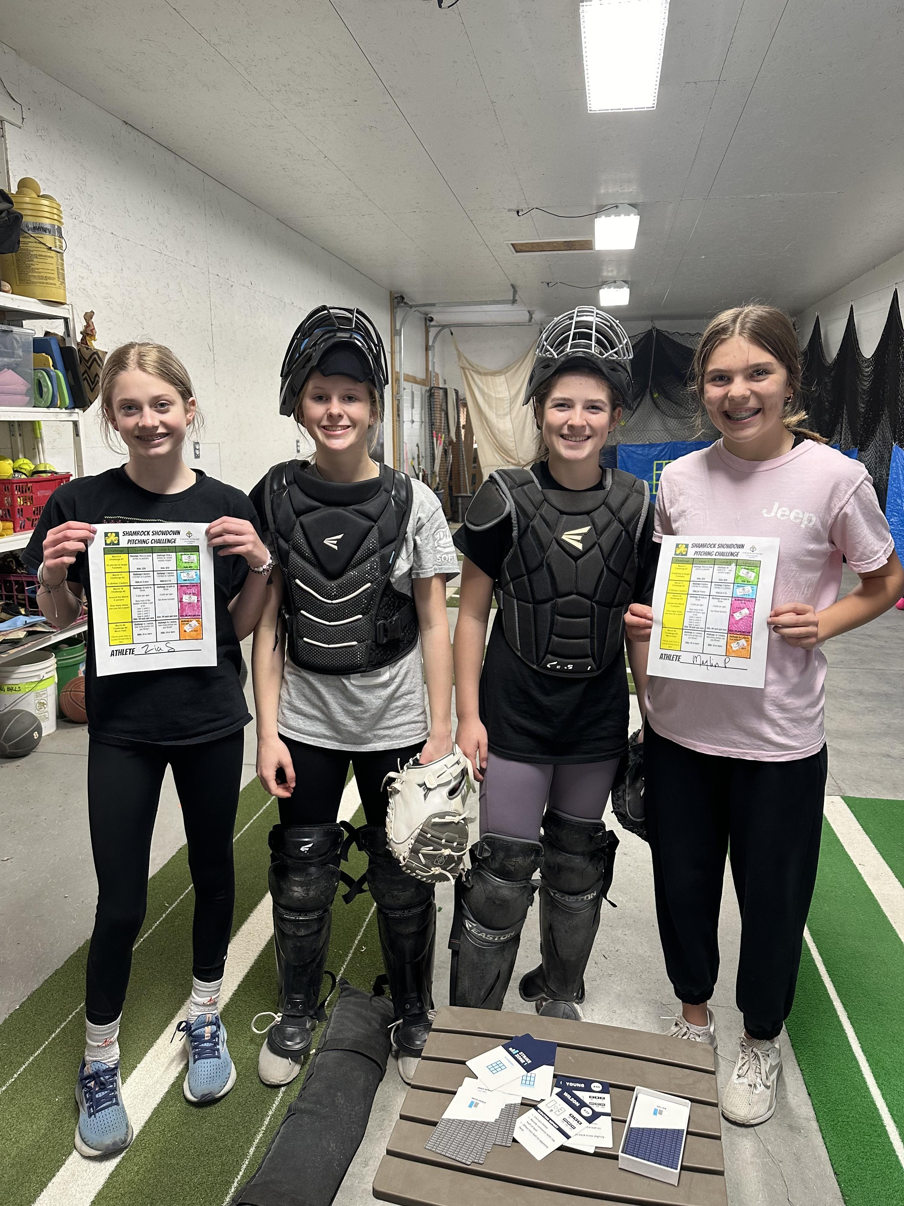 Athletes and coach holding pitching challenge scorecards
